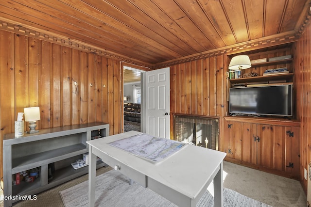 dining area featuring carpet, wooden walls, and wood ceiling