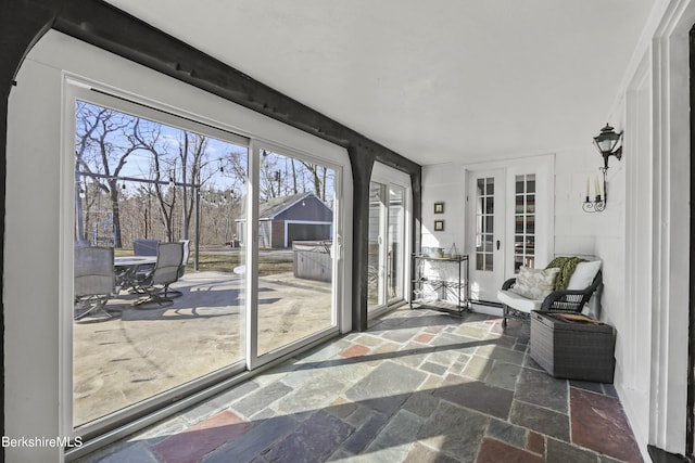 sunroom / solarium with a baseboard heating unit