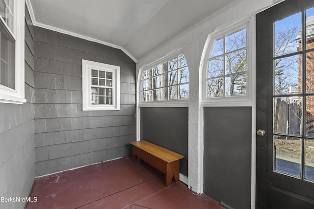 sunroom / solarium featuring lofted ceiling