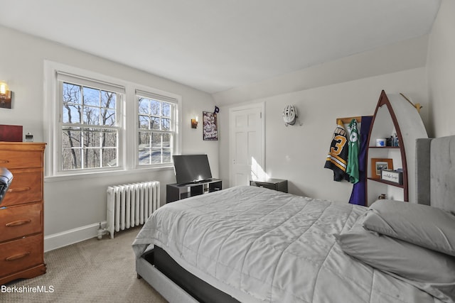 bedroom with radiator, carpet, and baseboards