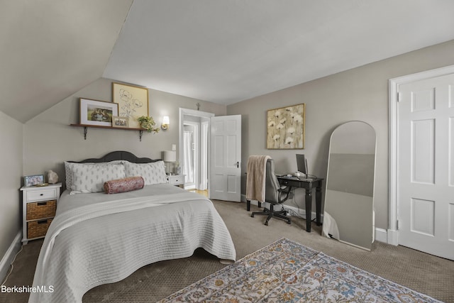 bedroom featuring baseboards, lofted ceiling, and carpet