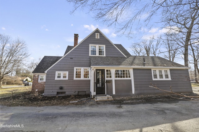 view of front of property featuring roof with shingles and a chimney