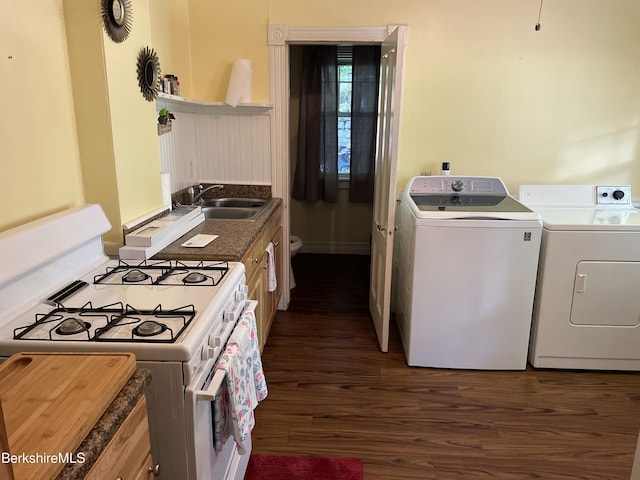 kitchen featuring white range with gas cooktop, dark hardwood / wood-style flooring, sink, and washer and clothes dryer