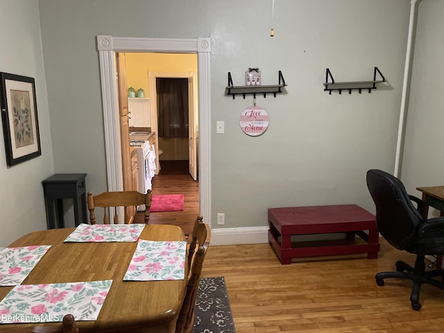 dining space with hardwood / wood-style floors