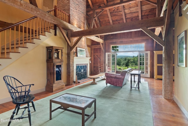 25 Sheffield Rd, Egremont, MA 01230 - living room featuring high vaulted ceiling, hardwood / wood-style floors, stairway, a wooden ceiling with exposed beams, and a large fireplace