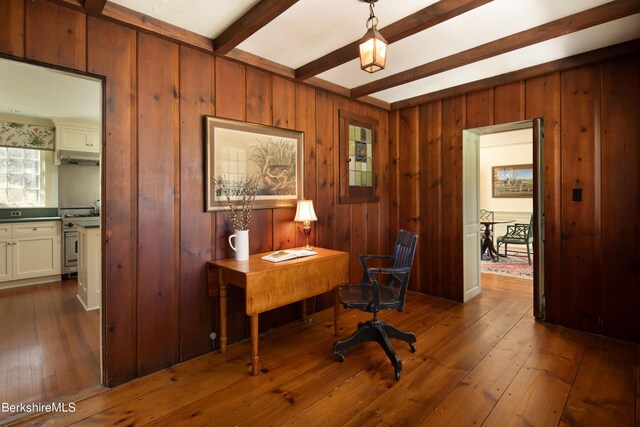 home office featuring beam ceiling, dark hardwood / wood-style flooring, and sink