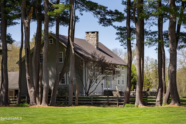 back of property with a lawn