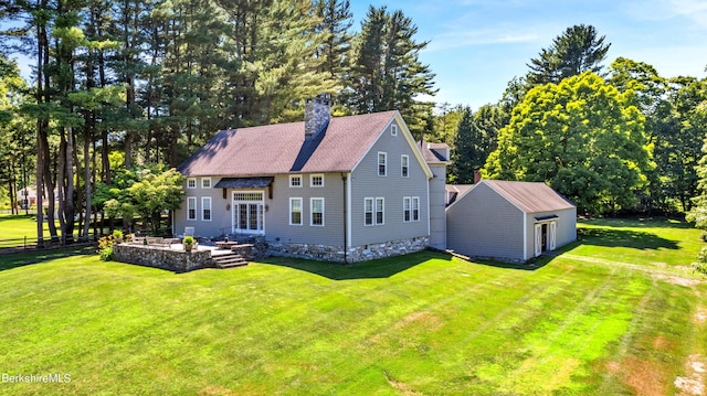 exterior space featuring a lawn and an outdoor structure