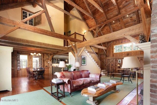 living room with beam ceiling, an inviting chandelier, high vaulted ceiling, wooden ceiling, and hardwood / wood-style floors