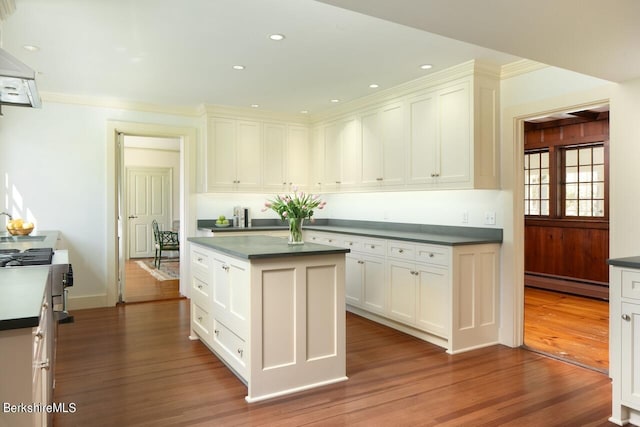 25 Sheffield Rd, Egremont, MA 01230 - kitchen with a baseboard heating unit, dark countertops, wood finished floors, white cabinetry, and extractor fan