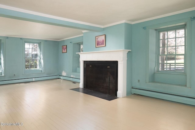 unfurnished living room featuring crown molding, baseboard heating, and a wealth of natural light