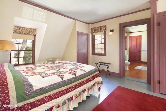 bedroom with connected bathroom, radiator, and ornamental molding