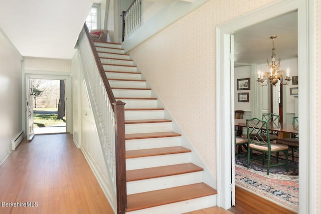 25 Sheffield Rd, Egremont, MA 01230 - stairway with wallpapered walls, wood finished floors, a baseboard heating unit, and a chandelier