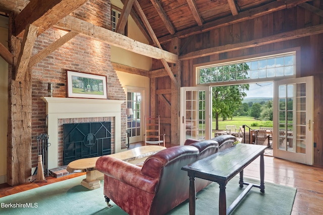 25 Sheffield Rd, Egremont, MA 01230 - living area featuring high vaulted ceiling, hardwood / wood-style floors, a wood ceiling with exposed beams, and a brick fireplace