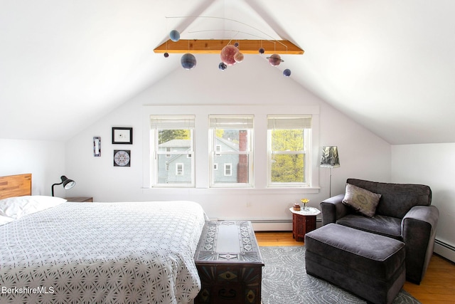 bedroom featuring a baseboard radiator, vaulted ceiling with beams, and wood finished floors