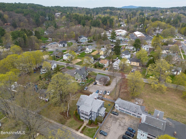drone / aerial view with a residential view and a wooded view