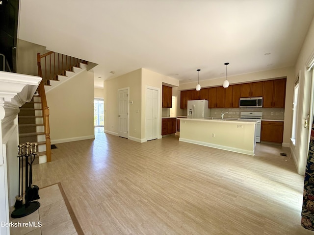 2 Copper Beech Ln, Great Barrington, MA 01230 - unfurnished living room featuring light wood-type flooring and stairs