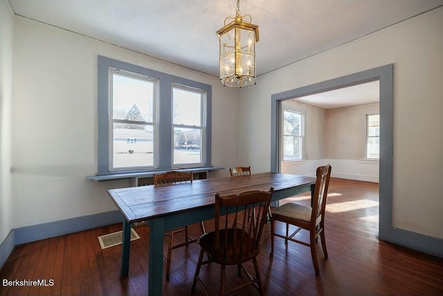 dining room featuring a chandelier and dark hardwood / wood-style floors