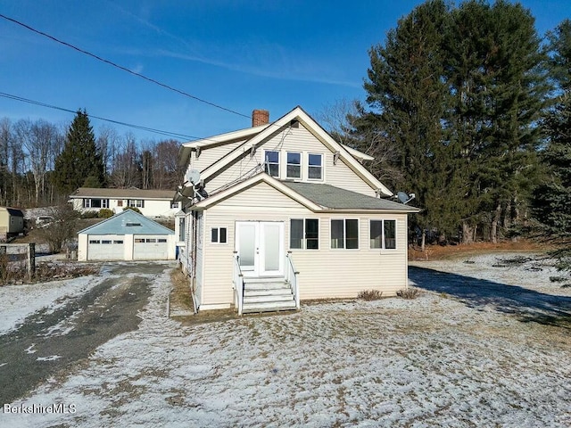 bungalow with an outdoor structure and a garage