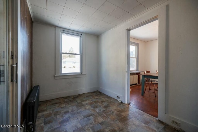 unfurnished room featuring radiator