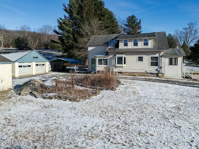 view of front of house featuring a carport and an outdoor structure