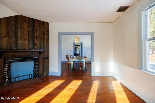 unfurnished living room with hardwood / wood-style floors and a healthy amount of sunlight