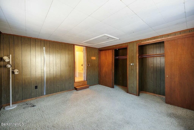 unfurnished bedroom featuring light carpet and elevator