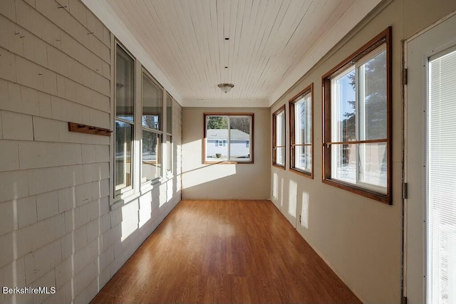 unfurnished sunroom featuring a healthy amount of sunlight and wood ceiling