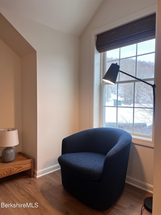 sitting room with hardwood / wood-style floors, a healthy amount of sunlight, and vaulted ceiling