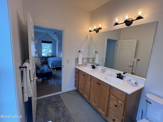 bathroom featuring tile patterned floors, vanity, and toilet