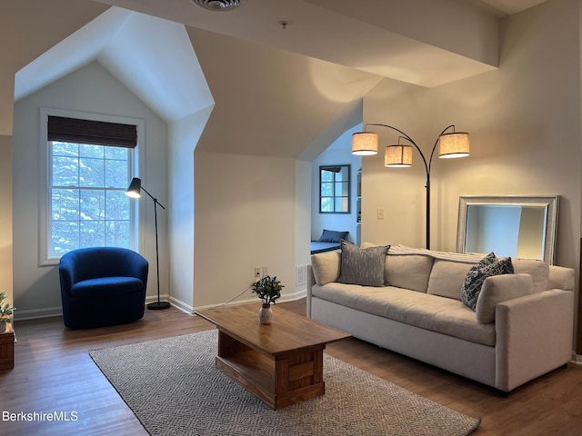 living room featuring hardwood / wood-style floors and lofted ceiling