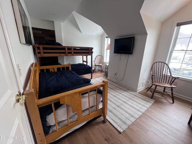 bedroom with hardwood / wood-style flooring and vaulted ceiling