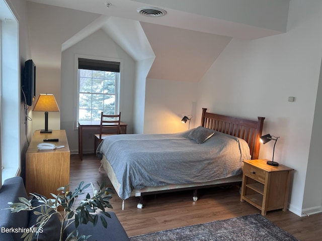 bedroom with dark hardwood / wood-style flooring and vaulted ceiling