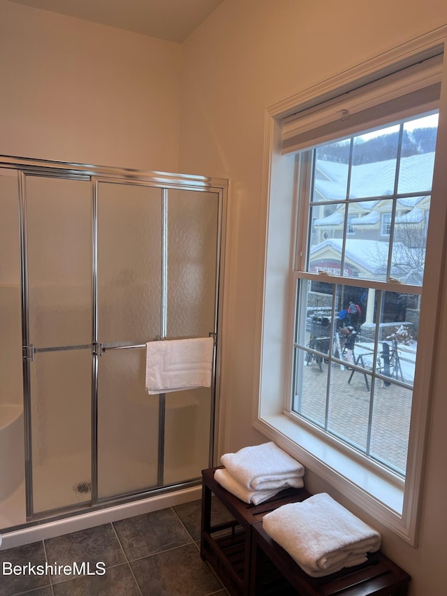 bathroom featuring tile patterned floors and a shower with shower door