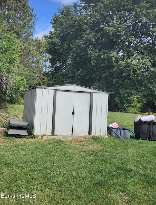 view of outdoor structure with a lawn