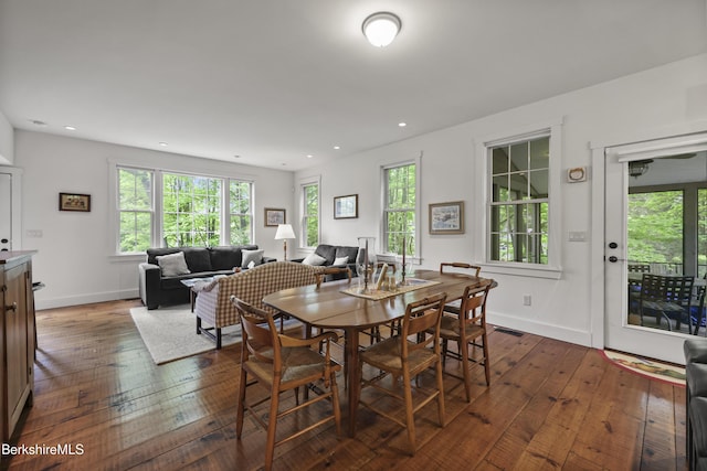 dining room with dark wood-type flooring, healthy amount of natural light, baseboards, and recessed lighting