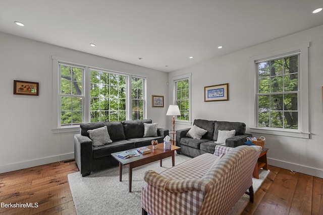 living room with healthy amount of natural light, hardwood / wood-style floors, baseboards, and recessed lighting