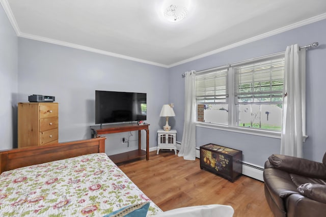 bedroom with baseboard heating, crown molding, and wood-type flooring