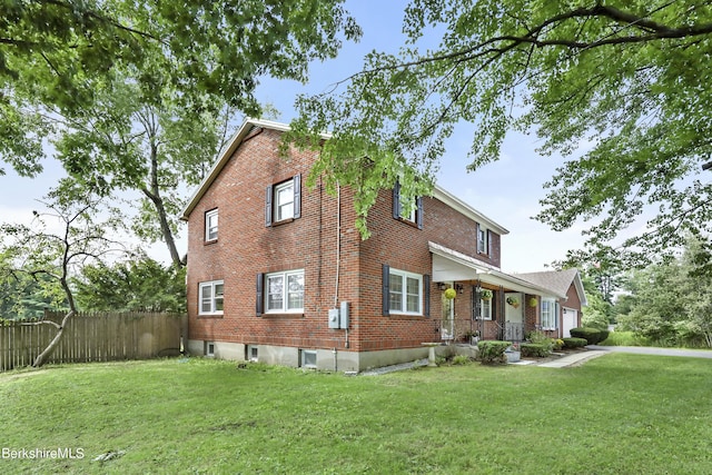 view of property exterior featuring a yard and covered porch