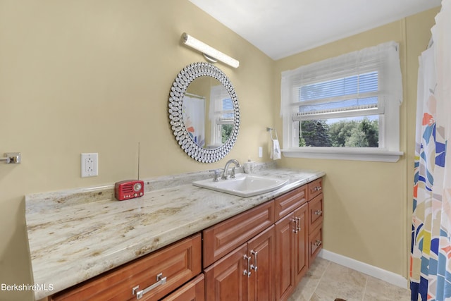 bathroom featuring tile patterned flooring and vanity