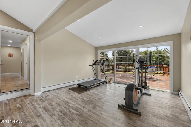 exercise area with baseboard heating, vaulted ceiling, and light wood-type flooring