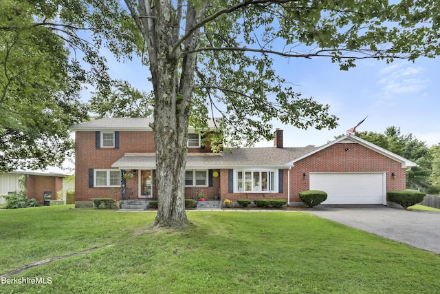 view of front of house with a front lawn and a garage