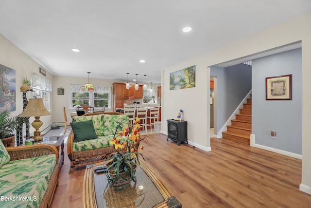 living room with light wood-type flooring and a wood stove