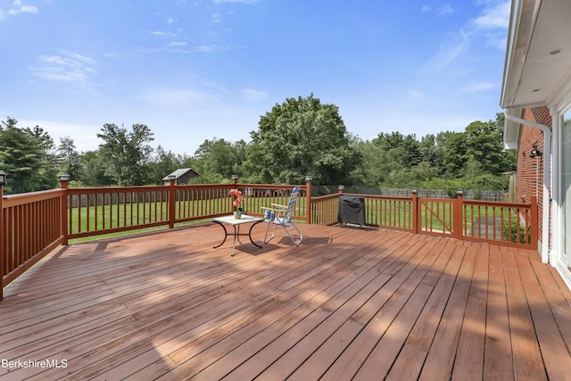 wooden terrace with a yard