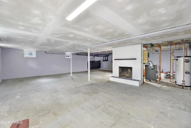 basement featuring a fireplace and gas water heater