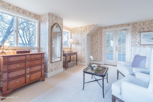 living room featuring a wealth of natural light, light carpet, and french doors