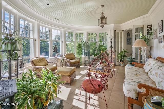 sunroom / solarium with a chandelier