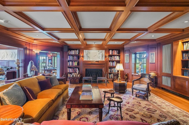 living room with beam ceiling, built in features, and coffered ceiling