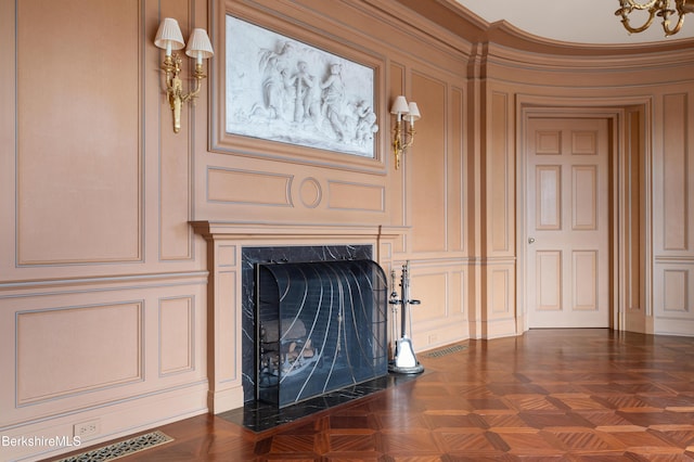 interior details with a fireplace, parquet floors, and ornamental molding