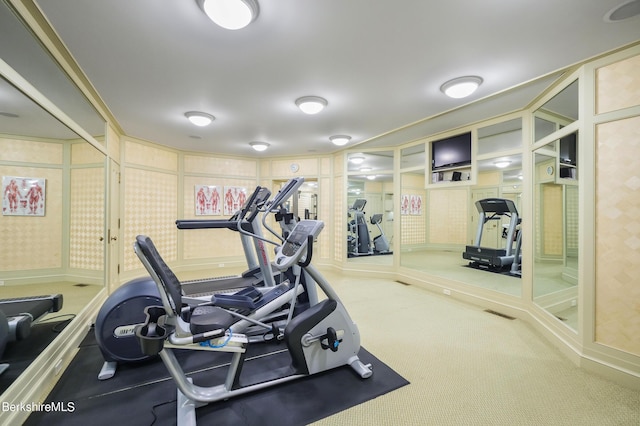 workout room with crown molding and carpet floors